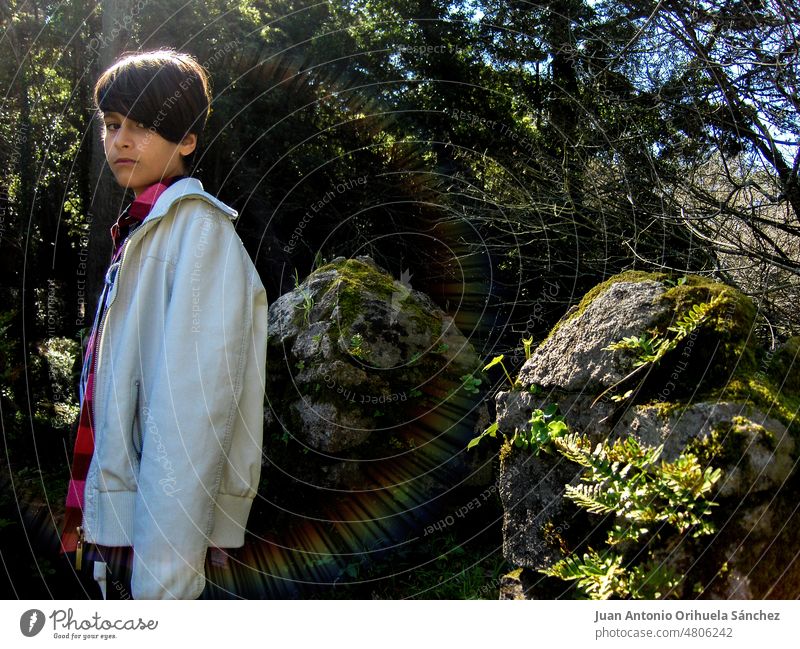 Portrait with rainbow light effect, of a boy posing on the battlements of the Castelo dos Mouros, located in Sintra, Lisbon, Portugal. castelo dos mouros child