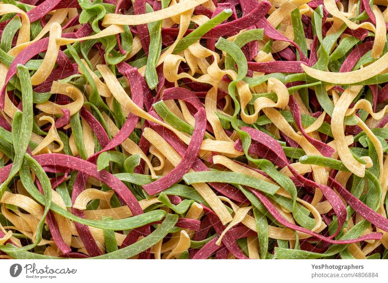 Tricolor pasta above view. Background of uncooked italian pasta abstract backdrop background beet bright carbs classic close-up cuisine delicious details dry