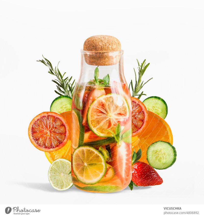 Infused water bottle with ingredients: cucumber, grapefruit, lime, lemon, strawberries and rosemary at white background. infused water refreshing natural
