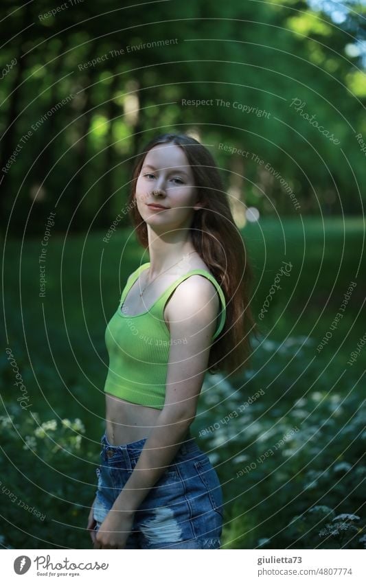 Summer portrait of long haired teen girl with short jeans shorts and belly top in park Human being Girl Young woman Long-haired May June Youth (Young adults)