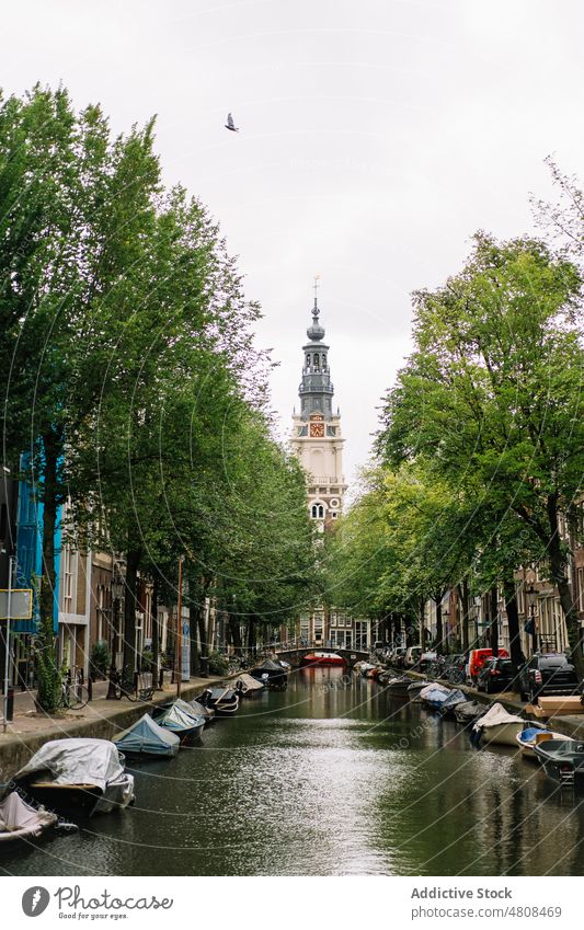 Scenic cityscape with old Protestant church and boats on canal architecture sightseeing building district culture picturesque facade protestant residential