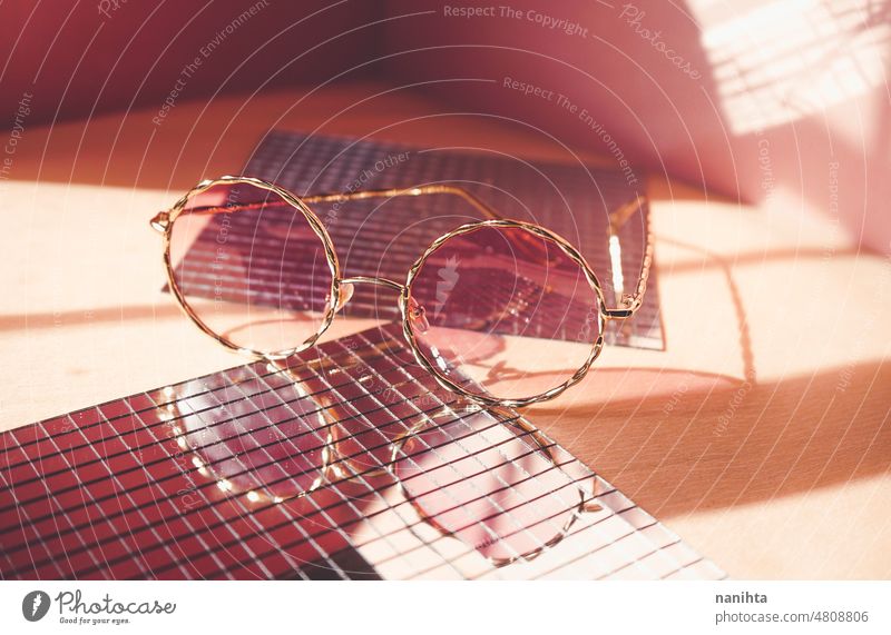 Studio shot of trendy female sunglasses in coral tones for summer fashion pink product still life mirror retro vintage reflection studio style golden stylish