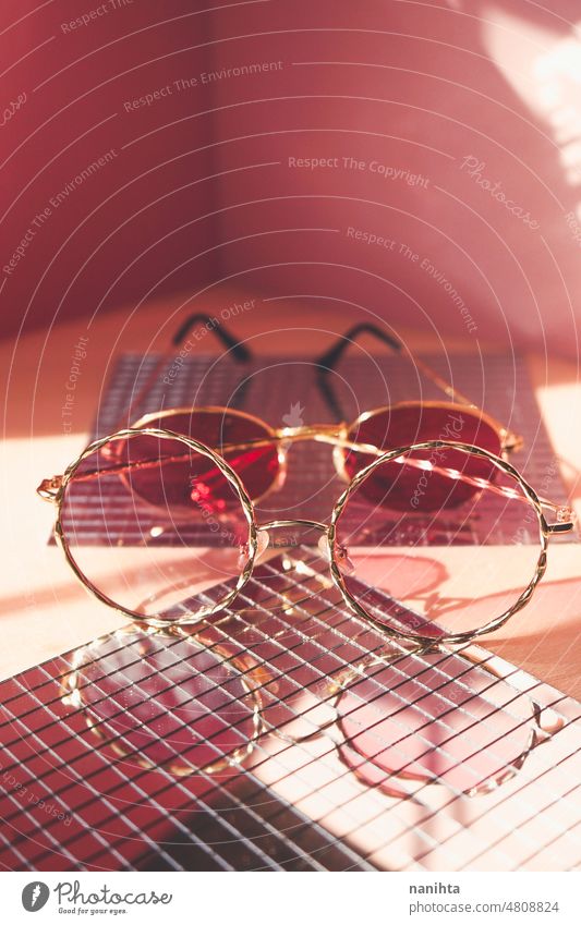 Studio shot of trendy female sunglasses in coral and red tones for summer fashion pink product still life mirror retro vintage reflection group pair studio