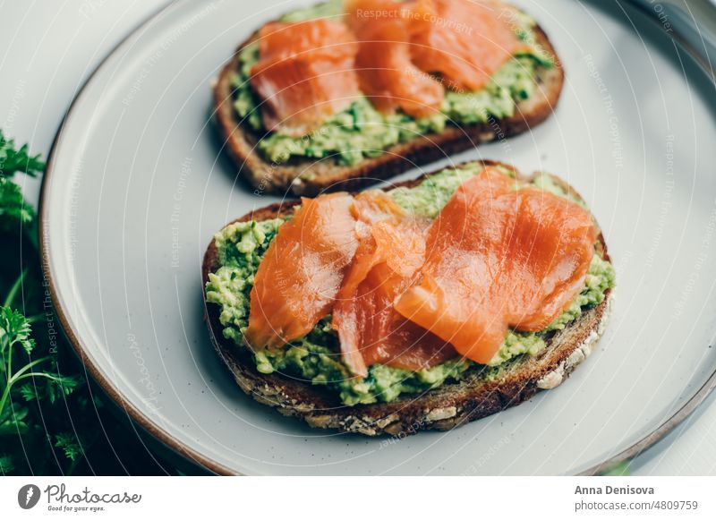Toast with avocado and salmon toast smoked salmon mashed bread lunch breakfast fresh food fish healthy delicious snack gourmet meal slice sandwich cheese