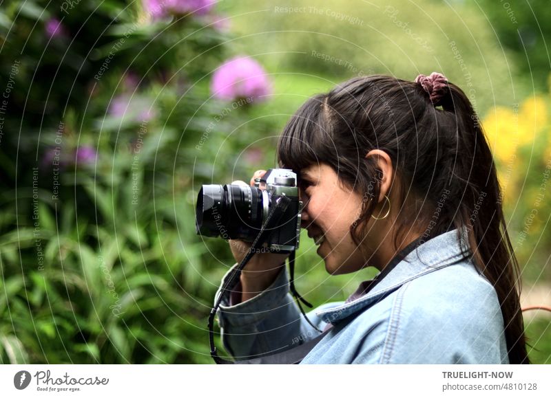 [Hansa BER 2022] Happy young woman and photographer enjoys the splendor of flowers in May with her camera portrait Young woman Profile Head Shoulder Face Joy