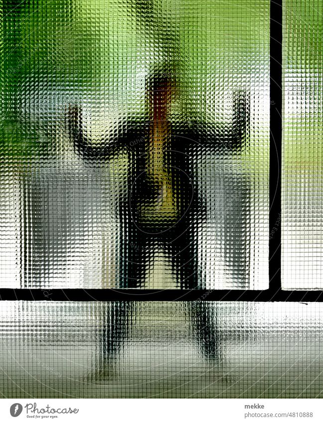 [hansa BER 2022] Jumping jack behind fluted glass pane Pane Window Window pane Transparent Vista hazy Human being Woman fax pose Sieg profit Winning pose Slice
