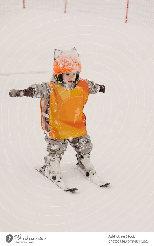 Cute kid practicing skiing on winter day child practice ski resort snow training activity sport active skier girl helmet brave toddler outerwear safety sporty