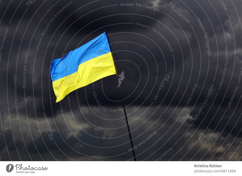 ukraine flag in front of dark clouds Ukraine Flag national colors Threat threatened symbolic symbol picture Blow Judder Sky Dark cloudy Clouds Blue Yellow Earth