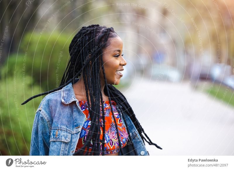 Portrait of a beautiful young woman in the city cool carefree confident day millennials dreadlocks enjoy authentic positive real people joyful toothy smile