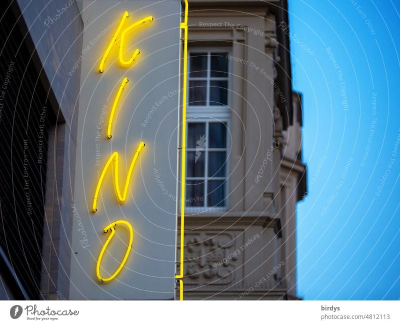 yellow neon sign " cinema " at a cinema in the evening Cinema Theatre Town Neon sign Word Characters Illuminated advertising evening sky Old building Neon light