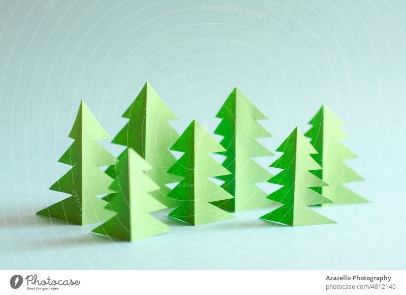 Green paper forest on blue background. Paper trees. abstract concept conceptual copy creative design ecological ecology environment environmental evergreen free