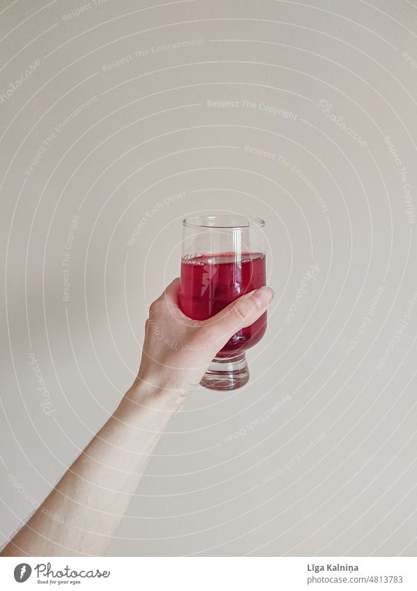 Hand holding red colored drink in glass Glass Wine glass Red To enjoy Beverage Drinking Colour photo Close-up Alcoholic drinks Style Vine Holder Juice