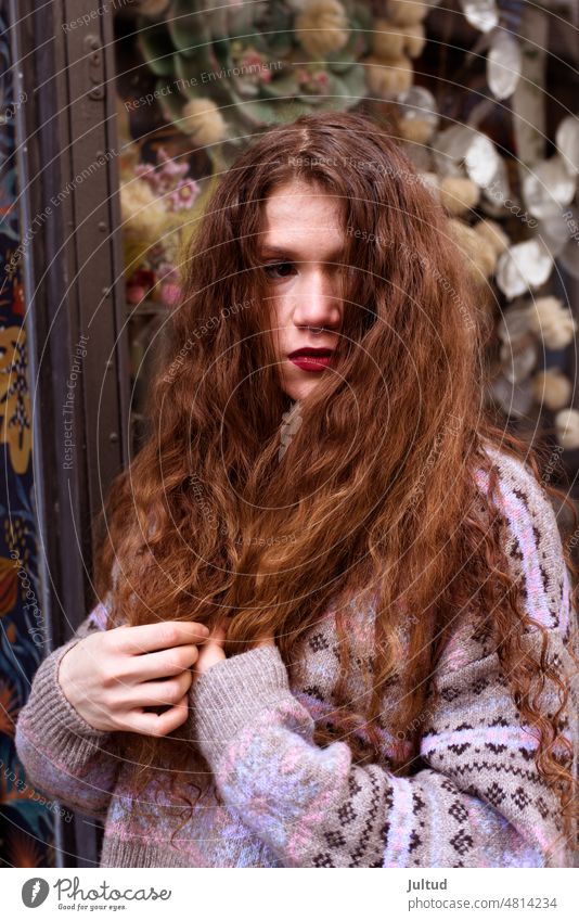 Portrait of young redheaded woman, on a city street natural girl naturally hair hairdressing hairstyle hairy lips lipstick red lips skin portrait