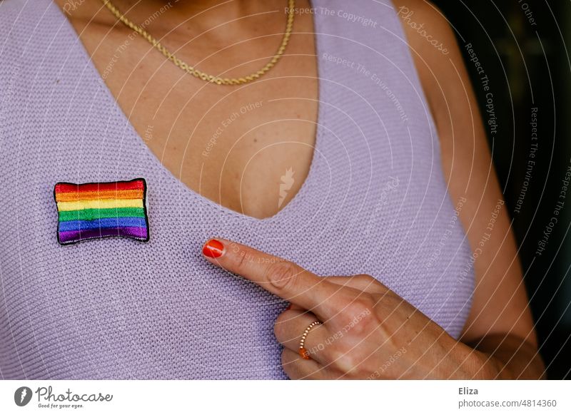 Woman points finger at rainbow flag pinned to her top Rainbow flag pride Tolerant variety Equality Freedom LGBTQ LGBTQ+ Pride purple symbol Love lesbian
