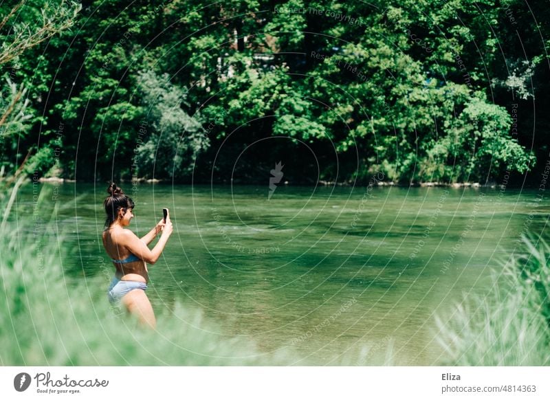 Woman in bikini photographing nature while bathing Bikini Take a photo bathe Lake River Nature Green Swimming & Bathing Water Summer Sun Body of water