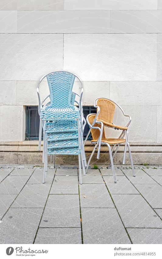 Stacked chairs in front of cafe Cane chair Chair Sit Tidy up Seating light blue Deserted Armchair Loneliness sad Closed Furniture Empty Gastronomy Table Café