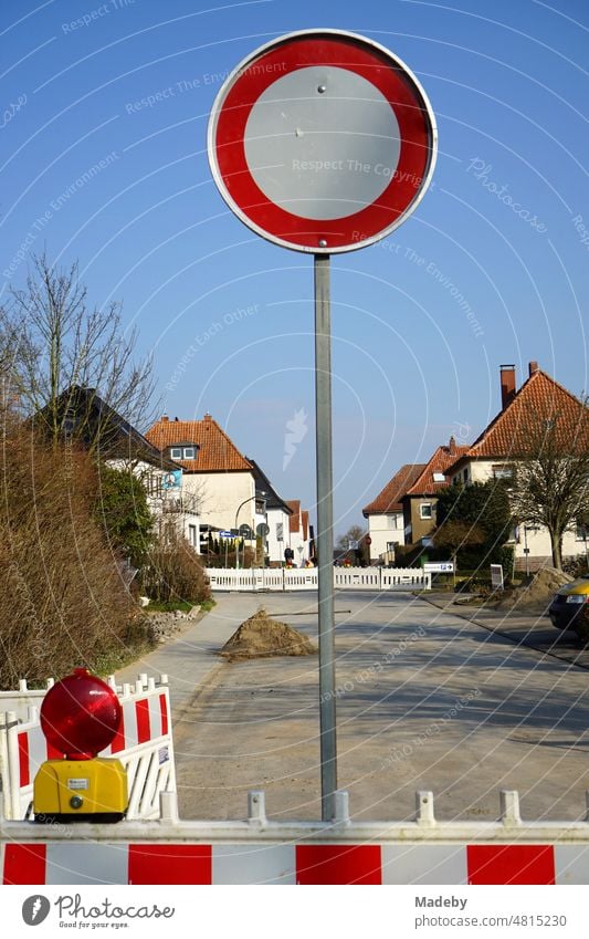 Passage forbidden with round traffic sign in front of blue sky in sunshine at a construction site on a road in Blomberg in East Westphalia-Lippe, Germany