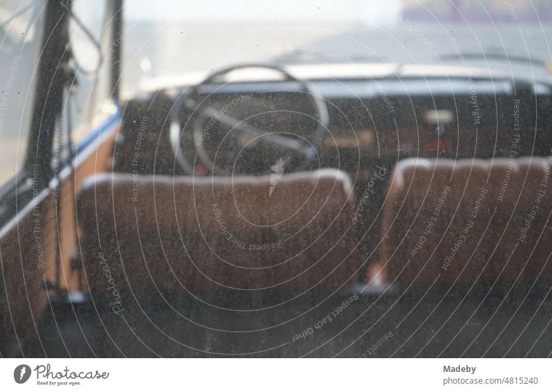 View through the dirty rear window on the interior and dashboard of a German rear engine small car of the sixties at the car museum in Lemgo Hörstmar near Detmold in East Westphalia Lippe
