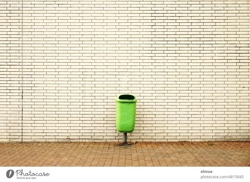 green waste container for residual waste in front of a building in beige clinker cladding / garbage disposal waste bins Outdoor waste collector Clinker cladding
