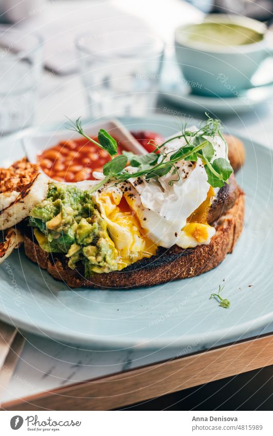 Healthy breakfast from poached eggs and veggies toast avocado vegetarian healthy food yolk sandwich grilled halloumi tofu mushrooms bread delicious