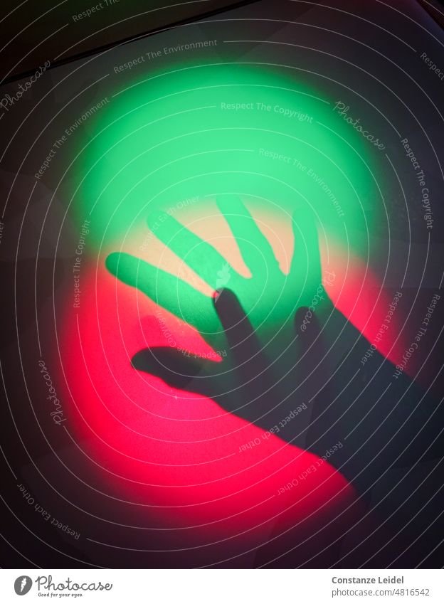 Two shadows hands in red and green light circle. Central perspective Light (Natural Phenomenon) Artificial light Neutral Background Pattern Abstract