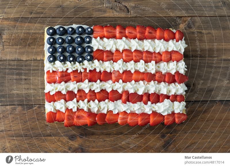 Cake with the colors of the US flag on a wooden background. Copy space. cake 4th july independence day USA United States of America celebration square table