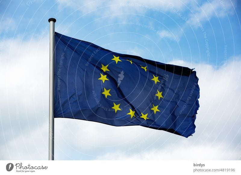 European flag in blue with yellow stars, European flag in front of sky European Union EU Flag Wind Blow Flagpole Sky Symbols and metaphors Blue