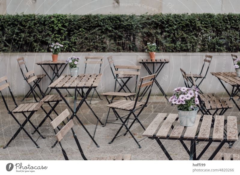 Tables with flowers and chairs of an outdoor restaurant tables Chair Sidewalk café Folding table Terrace Folding chair Restaurant Café Gastronomy