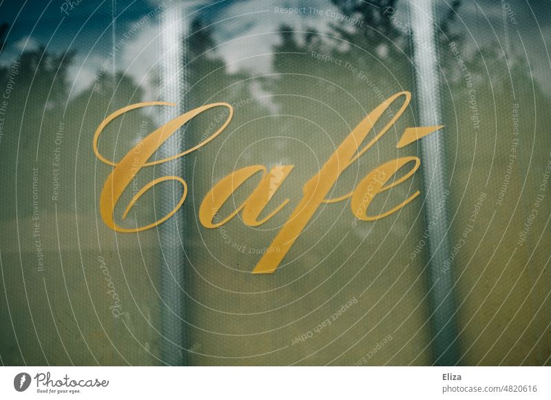 [hansa BER 2022] Golden lettering Café on a window pane Gastronomy writing Text authored Word Typography Coffee golden Pen Squiggly stale vintage Window pane