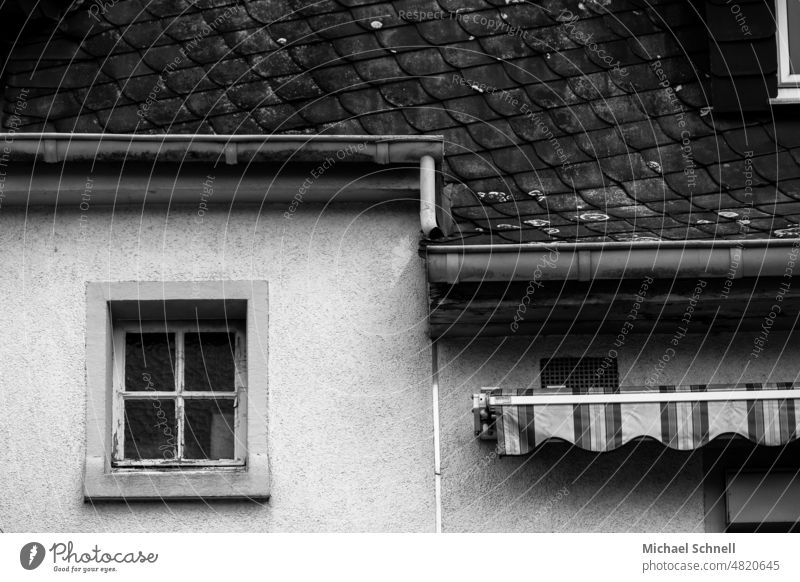 Old house facade: small window and awning Sun blind Gloomy dreariness Facade Building Architecture House (Residential Structure) Window Wall (building) Gray