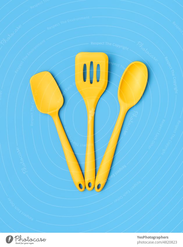 Silicone kitchenware above view. Yellow kitchen utensils on a blue table. background bakery blank bright chef close-up collection color colorful cooking
