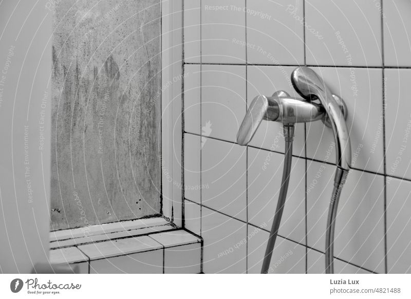 Hold me... Shower head lies gracefully on the mixer tap, the water long since turned off and the window dirty Shower faucet daintily Black & white photo