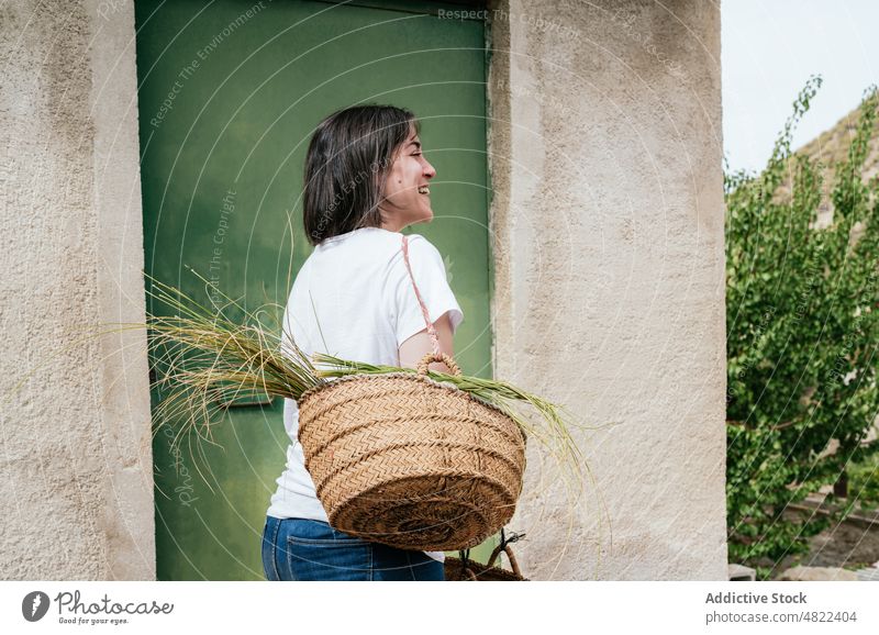 Smiling lady carrying basket with halfah grass woman smile wicker esparto countryside happy cheerful farm farmer nature stipa tenacissima female young hispanic