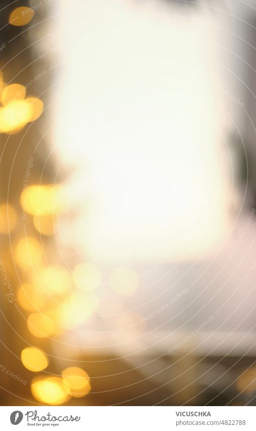 Blurred Christmas bokeh background with yellow light at window. blurred christmas front view copy space glowing bright defocused effect festive holiday home