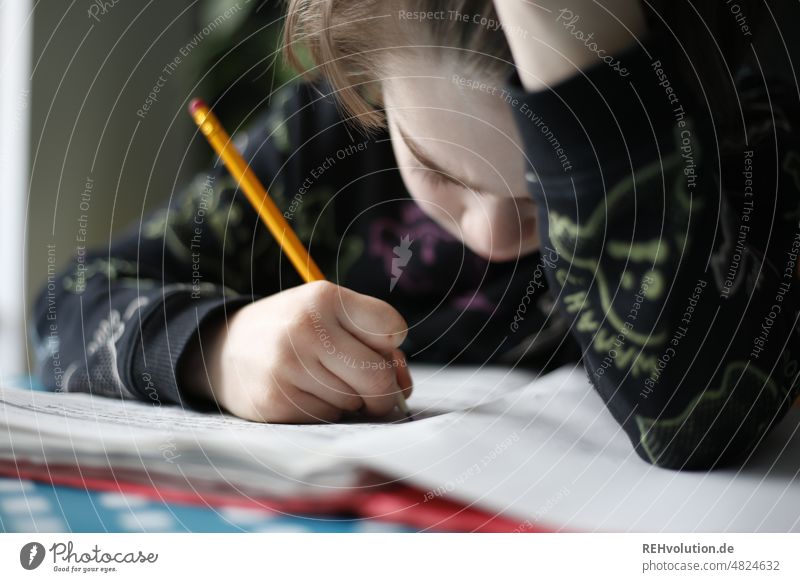 Child doing homework Boy (child) Homework Study School Infancy Student Education Sit Writing Write Elementary school Know Pencil Bad mood Concentrate