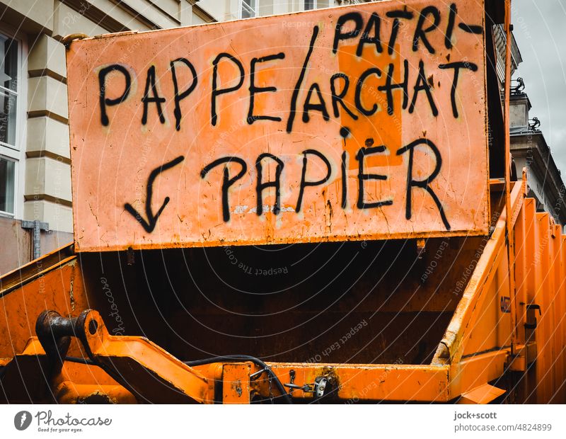 Cardboard, patriarchy and paper here in the container garbage container Word Paper patriarchal German Orange Handwriting Flap Creativity Street art Hint Open