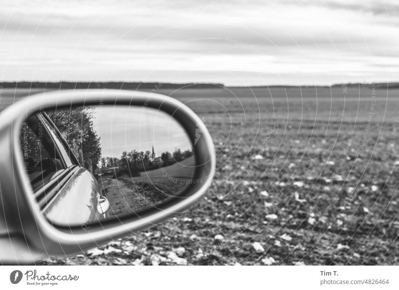 View through the side mirror Field Village Motoring Mirror Side mirror b/w Arable land Brandenburg B/W Black & white photo B&W Calm Day Deserted Exterior shot