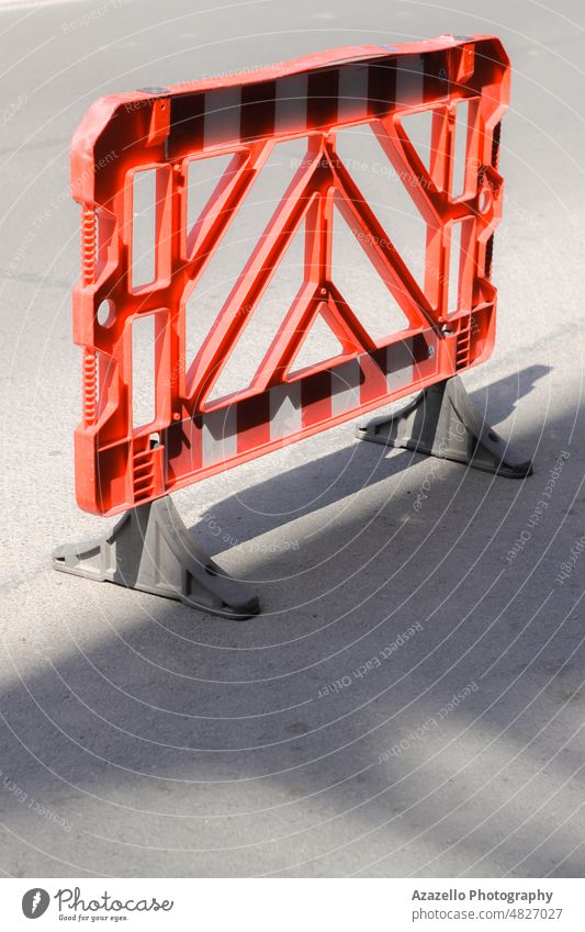 Red plastic reguration barrier on the road. obstacle highway driveway boundary damage warning no people maintenance fence closed attention build hole forbidden