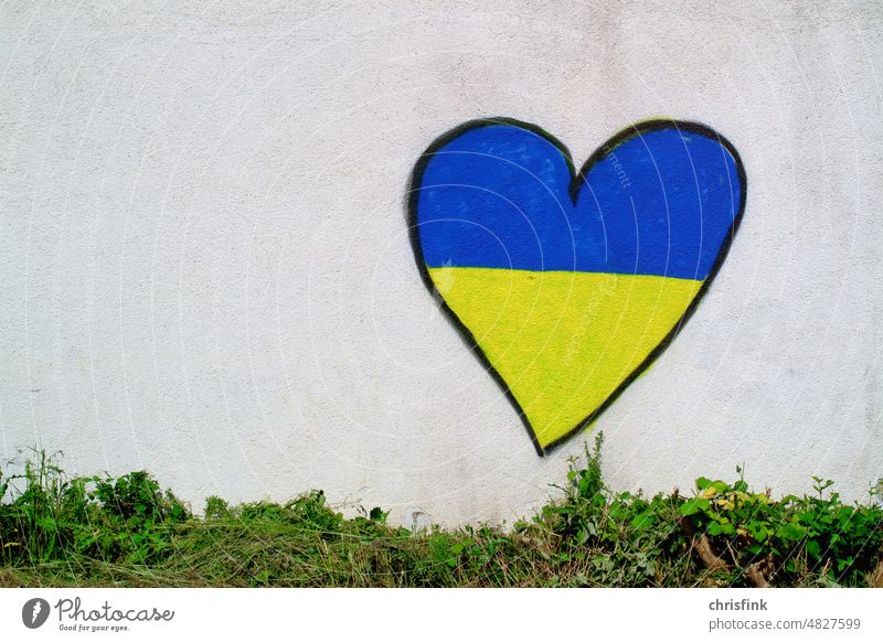 Heart on house wall with Ukraine colors graffiti Love Solidarity Peace Symbols and metaphors Freedom Politics and state Ukraine war Human rights Hope Sign War