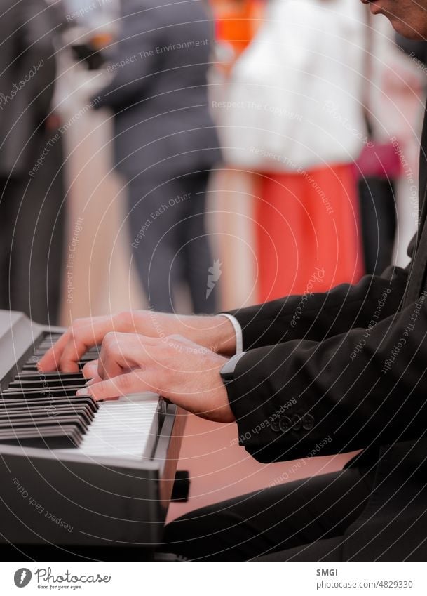 Close-up of the hands of a pianist playing during the celebration of an outdoor event music musician piano person man creativity finger sound woman adult close
