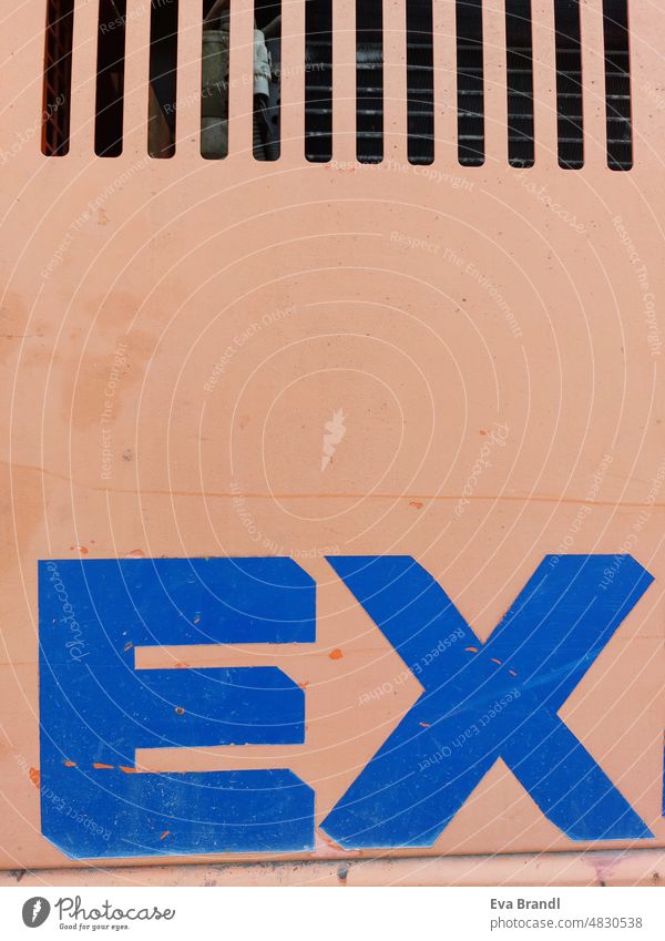 The word EX in blue color on orange background, on the upper edge ventilation slots Letters (alphabet) ex Characters Word Blue Orange Ventilation slots