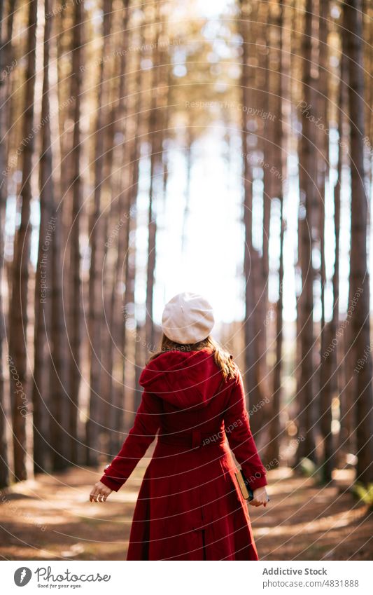 Anonymous woman standing holding book in autumn forest weekend tree outerwear positive female nature woodland beret redhead season fall notebook diary