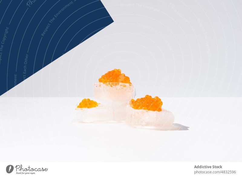 Orange tobiko caviar placed on ice flying fish roe bowl orange seafood delicious tradition dish cuisine culinary fresh palatable healthy gastronomy nutrition