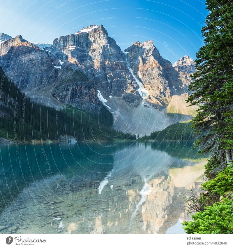 Moraine Lake in the morning at Sunrise in banff canada alberta america climbing conifer cream destination drift forest formation glacier hiking holiday ice