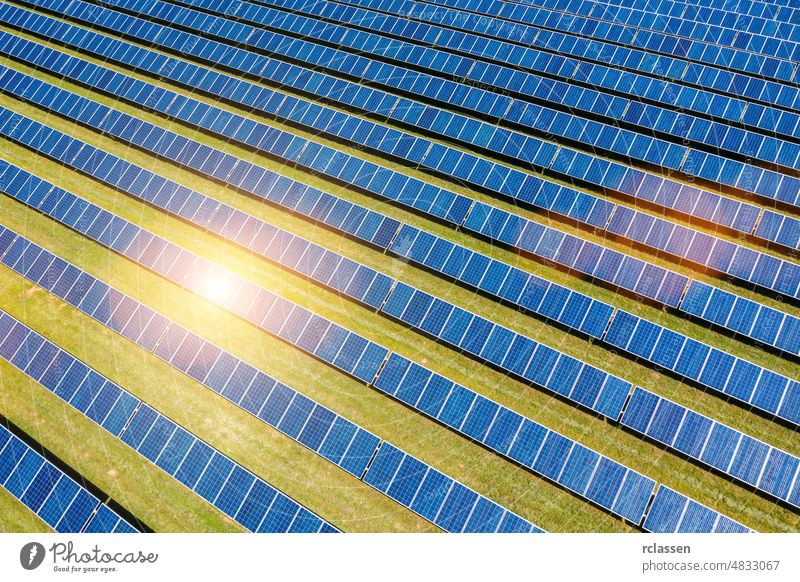 Aerial view of solar panels field, photovoltaic, alternative electricity drone energy industry blue sun flare sunlight cell clean collector eco ecological