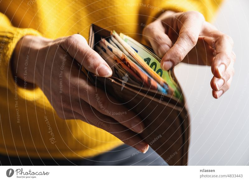 Female taking out euro money from her pocket wallet. counting money, economy concept, money distribution businesswoman female give hold payment shopping