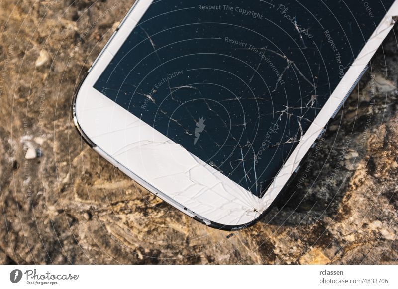 Broken Screen Smartphone broken screen cell stone mobile shattered white cellphone repair smashed glass smart display background accident black boots