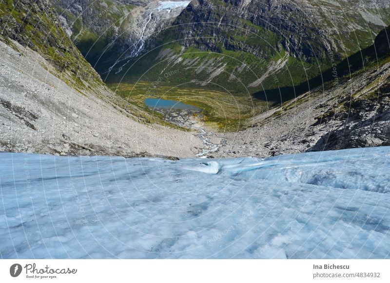 The view down from a glacier in Norway Glacier Ice on ice Valley frozen ground Blue Exterior shot Mountain Winter Summer in Norway Rock Landscape Nature