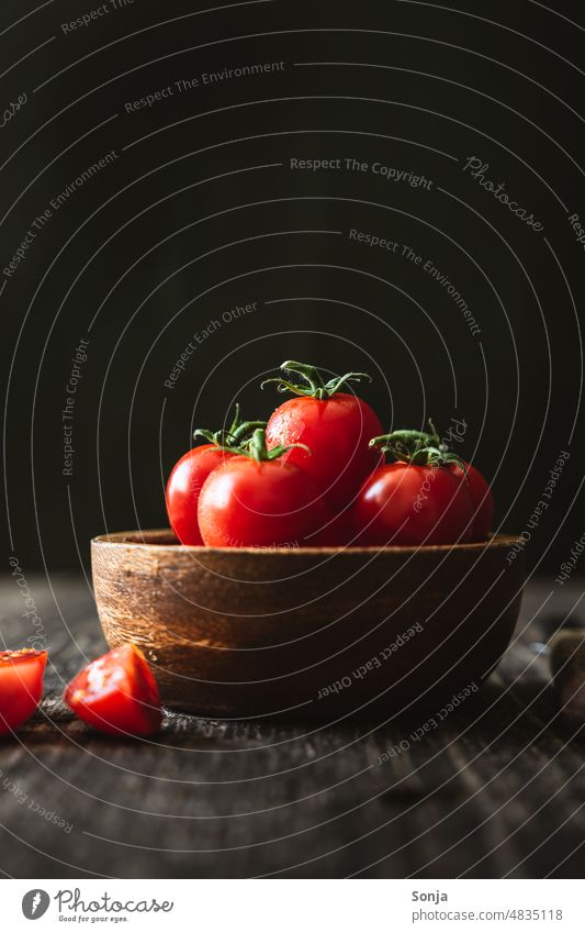 Fresh cocktail tomatoes in a wooden bowl.black background. Cocktail tomato Red Wood Vegetable Tomato Colour photo moody Organic produce Vegetarian diet