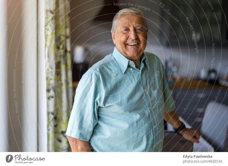 Portrait of a senior man standing in his home senior adult older aged portrait person casual leisure lifestyle pensioner caucasian retired people mature